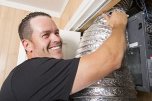 a man works on saving energy and sealing ducts in charleston